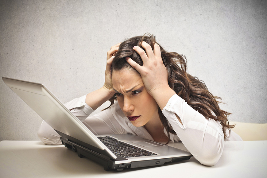 Is Your Business Prepared for Disasters? Stressed businesswoman looking over business disaster plan